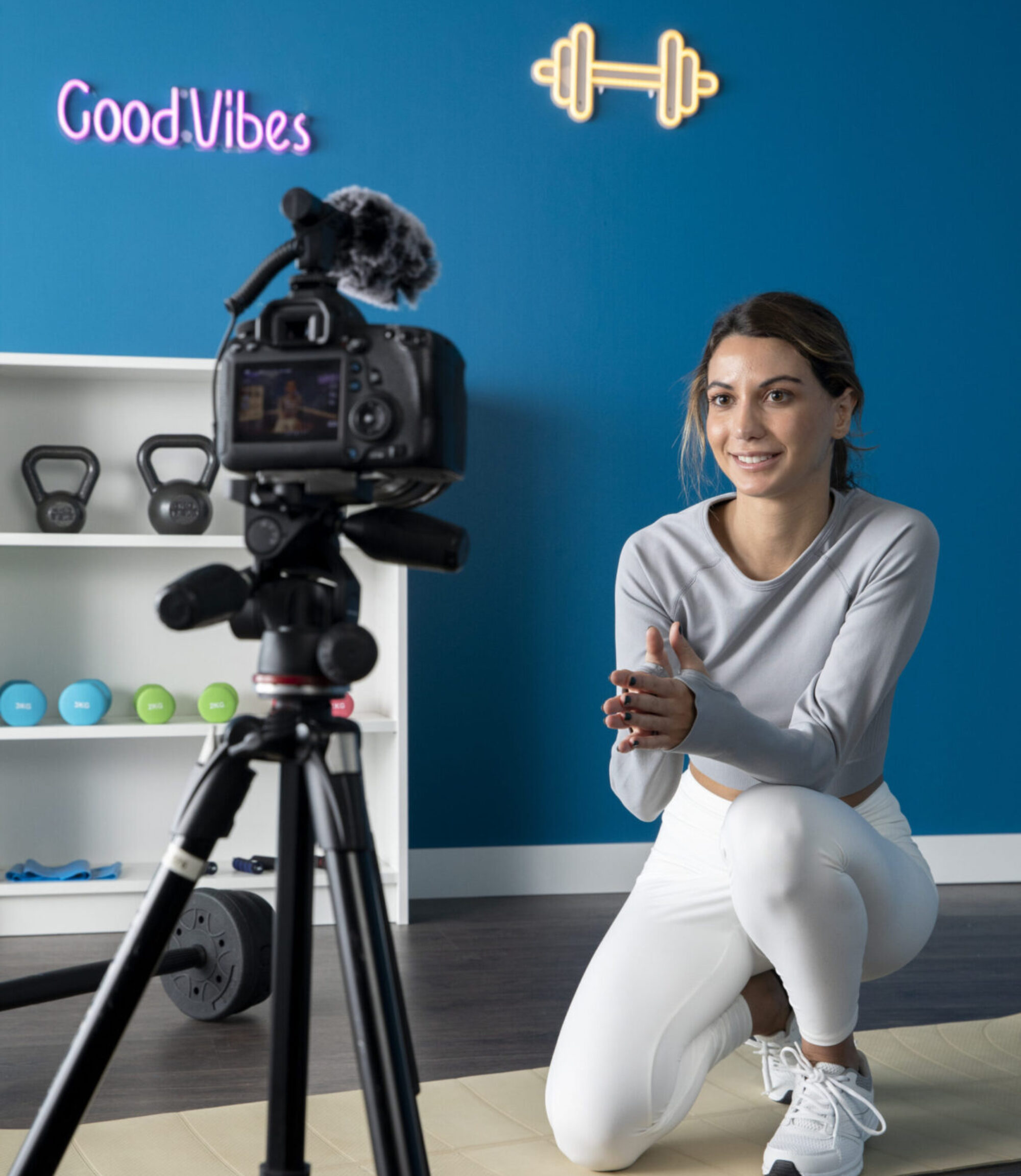 female-fitness-instructor-teaching-online-class-from-home-using-camera-tripod