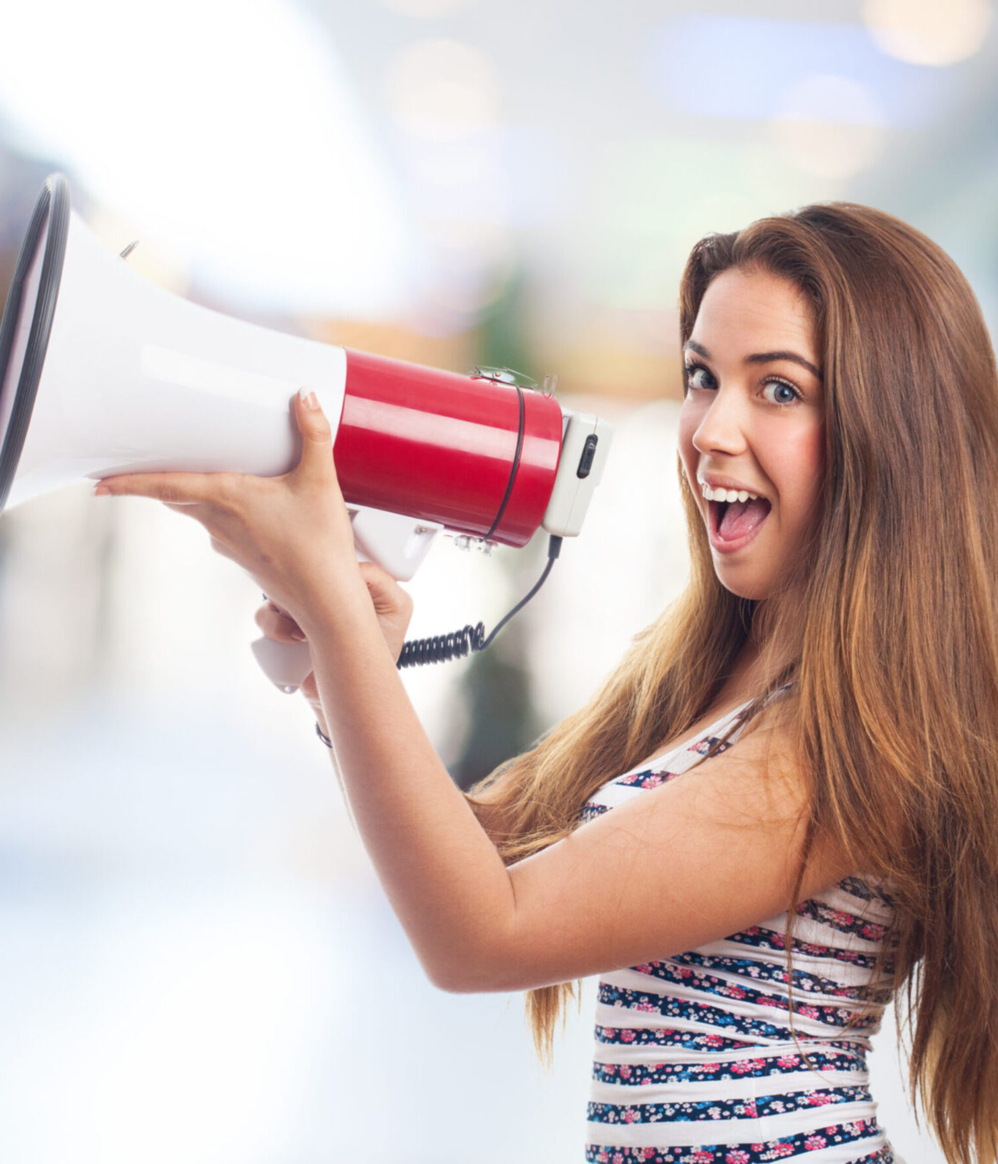 portrait of a girl shouting with a megaphone